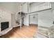 Spacious living room with fireplace and spiral staircase to the upper floor at 15350 E Arizona Ave # 308, Aurora, CO 80017
