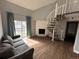 Living room with fireplace, spiral staircase, and sliding door to balcony at 15350 E Arizona Ave # 308, Aurora, CO 80017