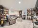 Finished basement with a comfortable seating area, shelving, and ample space for relaxation and entertainment at 12610 E Villanova Dr, Aurora, CO 80014