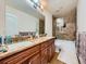 Spacious bathroom with dual sinks, granite countertops, and a separate shower-tub area at 12610 E Villanova Dr, Aurora, CO 80014