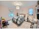 Bright bedroom designed with pink accents, featuring a cozy bed and ample natural light at 12610 E Villanova Dr, Aurora, CO 80014