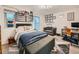 Cozy bedroom with a comfortable bed, organized display shelves, and a functional workspace at 12610 E Villanova Dr, Aurora, CO 80014