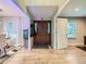 Bright foyer with wood-look tile, a stylish front door, and an adjacent dining area with a large window at 12610 E Villanova Dr, Aurora, CO 80014