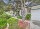 Inviting front yard with lush landscaping, mature trees, and a brick pathway leading to the front door at 12610 E Villanova Dr, Aurora, CO 80014
