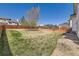 Spacious backyard with a well-maintained lawn, mature trees, and a privacy fence at 12771 Clermont St, Thornton, CO 80241