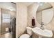 Convenient half bath featuring a pedestal sink, toilet, and in-unit laundry space at 12771 Clermont St, Thornton, CO 80241