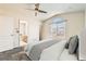 Cozy bedroom with neutral tones, vaulted ceilings, and ample natural light from the arched window at 12771 Clermont St, Thornton, CO 80241