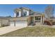 Charming two-story home featuring stone accents, a welcoming front porch, and a spacious three-car garage at 12771 Clermont St, Thornton, CO 80241