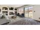 Cozy living room featuring a fireplace, built-in shelving, and sliding doors to the backyard at 12771 Clermont St, Thornton, CO 80241