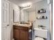 Well-lit bathroom with a vanity, decorative shelves and a neutral color scheme at 2575 S Syracuse Way # B107, Denver, CO 80231
