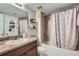 Cozy bathroom featuring a shower-tub combination and a vanity with granite countertops at 2575 S Syracuse Way # B107, Denver, CO 80231