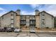 View of the exterior of the condo building with balconies and well-maintained landscaping at 2575 S Syracuse Way # B107, Denver, CO 80231