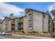 Condominium exterior with stone accents, balconies, and landscaped grounds at 2575 S Syracuse Way # B107, Denver, CO 80231