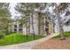 Condominium exterior with stone accents, lush landscaping, and a well-maintained walkway at 2575 S Syracuse Way # B107, Denver, CO 80231
