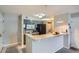Modern kitchen with gray cabinets and granite counter open to the dining area and in-unit laundry at 2575 S Syracuse Way # B107, Denver, CO 80231