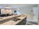 Open concept kitchen featuring granite counter bar and modern stainless-steel faucet at 2575 S Syracuse Way # B107, Denver, CO 80231