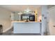 Compact kitchen featuring a convenient breakfast bar and updated black appliances at 2575 S Syracuse Way # B107, Denver, CO 80231
