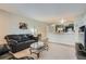 Bright and welcoming living room with comfortable seating area and granite kitchen bar at 2575 S Syracuse Way # B107, Denver, CO 80231