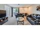 Bright living room featuring plush carpet, modern decor, and sliding glass doors at 2575 S Syracuse Way # B107, Denver, CO 80231