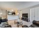Open-concept living room with stylish sofas, and a partial view of the kitchen bar at 2575 S Syracuse Way # B107, Denver, CO 80231