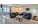 Inviting living room with black leather sofas and sliding doors to the outside at 2575 S Syracuse Way # B107, Denver, CO 80231