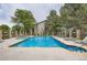 Resort-style swimming pool with lounge chairs, lush trees, and a clubhouse at 2575 S Syracuse Way # B107, Denver, CO 80231