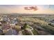 Vast aerial view of a community with scenic walking trails and city buildings in the distance at 13753 Jasmine St, Thornton, CO 80602