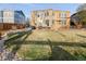 Beautiful backyard with a large lawn, patio, fire pit seating, and mature landscaping, ideal for Gathering gatherings at 13753 Jasmine St, Thornton, CO 80602