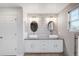 Stylish bathroom with a granite-topped double vanity and wood-look tile flooring, perfect for a luxurious and relaxing experience at 13753 Jasmine St, Thornton, CO 80602