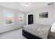 Inviting bedroom with a queen-size bed, two windows, black bookshelf, and contemporary artwork on the wall at 13753 Jasmine St, Thornton, CO 80602