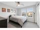 Bright bedroom showcasing a queen-size bed, neutral gray walls, and two large windows offering neighborhood views at 13753 Jasmine St, Thornton, CO 80602