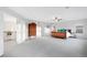 Spacious bedroom with a large wooden bed and vintage dresser, plus a connecting landing area with an open staircase at 13753 Jasmine St, Thornton, CO 80602