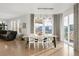 Bright dining area with hardwood floors, large windows, and access to the backyard at 13753 Jasmine St, Thornton, CO 80602