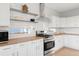 Well-appointed kitchen boasts stainless steel appliances, butcher block counters, and modern finishes at 13753 Jasmine St, Thornton, CO 80602