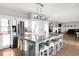 Open kitchen with large island, stainless steel appliances, and seamless flow to the living area at 13753 Jasmine St, Thornton, CO 80602