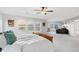 Sun-drenched main bedroom features large windows, ceiling fan, and a workspace, providing a bright and comfortable retreat at 13753 Jasmine St, Thornton, CO 80602