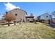 Landscaped backyard featuring green grass, a pergola with a hot tub, and a cozy patio at 10732 Cook Ct, Northglenn, CO 80233