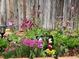 Backyard garden with colorful flowerbeds and decorative figurines, creating a whimsical outdoor setting at 10732 Cook Ct, Northglenn, CO 80233