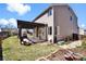 Spacious backyard with a pergola-covered patio, hot tub, lush lawn, and well-maintained landscaping at 10732 Cook Ct, Northglenn, CO 80233