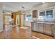 Open concept kitchen with stainless steel appliances, view into the living area, and hardwood floors at 10732 Cook Ct, Northglenn, CO 80233