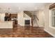 Open floor plan with kitchen island and a cozy fireplace at 8482 Parkland St, Broomfield, CO 80021