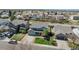 Aerial view of a neighborhood featuring a green home with a two-car garage and well-manicured lawn at 5149 S Tibet St, Aurora, CO 80015