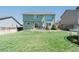 Large backyard features a well-maintained lawn, patio, and a two-story home at 5149 S Tibet St, Aurora, CO 80015
