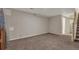 Unfinished basement offers a large, flexible space with neutral carpeting and access to stairs at 5149 S Tibet St, Aurora, CO 80015