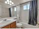 Well-lit bathroom featuring a shower over tub combination, white tile, and modern fixtures at 5149 S Tibet St, Aurora, CO 80015