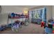 Bright bedroom with a playful bunk bed, colorful curtains, and a large window at 5149 S Tibet St, Aurora, CO 80015