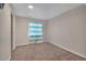 Simple bedroom with neutral carpet, a window with curtains, and bright natural light at 5149 S Tibet St, Aurora, CO 80015
