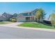 Charming two-story home with a well-manicured lawn and a two car garage on a bright sunny day at 5149 S Tibet St, Aurora, CO 80015