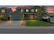 Charming two-story home with a well-manicured lawn and a two car garage during a beautiful twilight at 5149 S Tibet St, Aurora, CO 80015