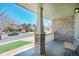Inviting front porch with brick accents offering a charming view of the well-maintained street and neighborhood at 5149 S Tibet St, Aurora, CO 80015
